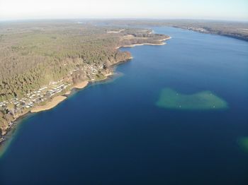 High angle view of sea and land against sky