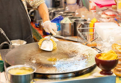 Midsection of woman preparing food