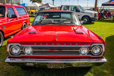 Red vintage car on street in city