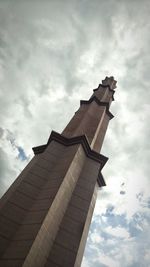 Low angle view of eiffel tower against cloudy sky