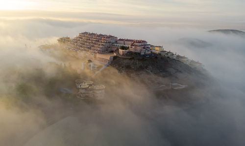 High angle view of buildings by sea against sky