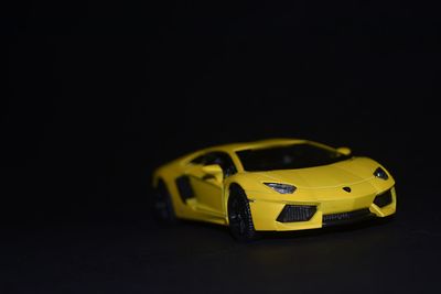 Close-up of toy car over black background