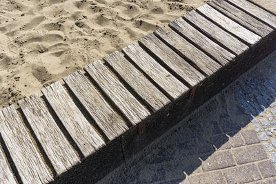 High angle view of wooden boardwalk on beach