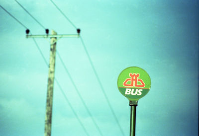 Low angle view of road sign against sky