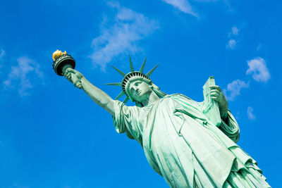 Low angle view of statue against blue sky