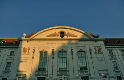 Low angle view of building against clear blue sky