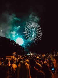 People watching firework display at night