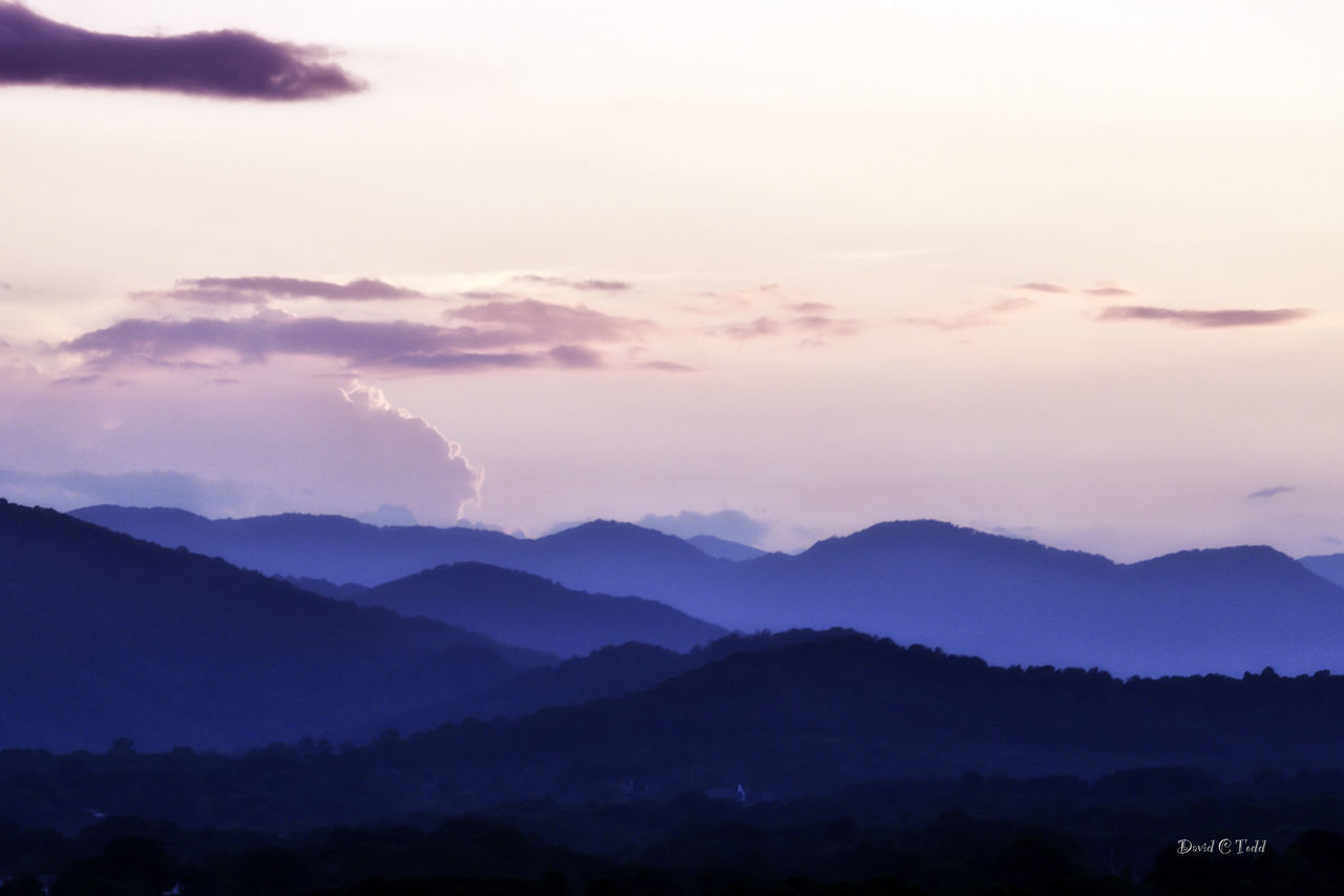 SCENIC VIEW OF SILHOUETTE MOUNTAINS AGAINST SKY