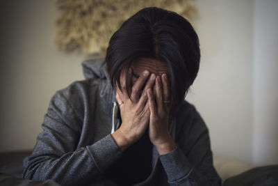 Man facing depression with hands covering his face