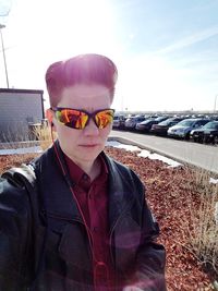 Portrait of mid adult man standing against sky