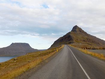 Road amidst mountains against sky