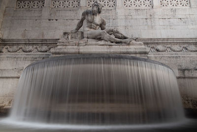 Low angle view of statue against fountain