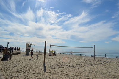 Group of people on beach against sky