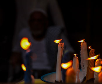 Illuminated candles burning at night