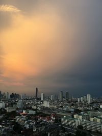 Buildings in city against sky during sunset