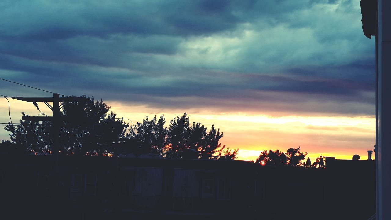 sunset, sky, cloud - sky, silhouette, cloudy, tree, orange color, cloud, beauty in nature, dramatic sky, built structure, nature, scenics, building exterior, architecture, tranquility, house, tranquil scene, low angle view, overcast