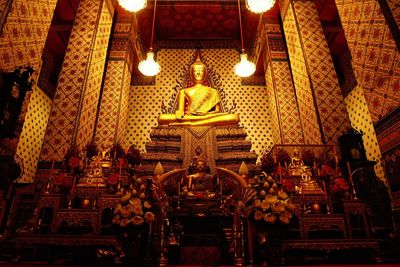 Low angle view of illuminated statues in building