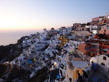 High angle view of townscape by sea against sky