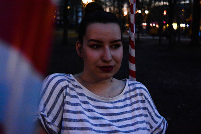 Portrait of young man looking away at night