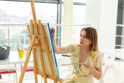 Young woman on window at home