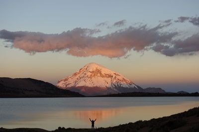 Scenic view of snowcapped mountains against sky during sunset