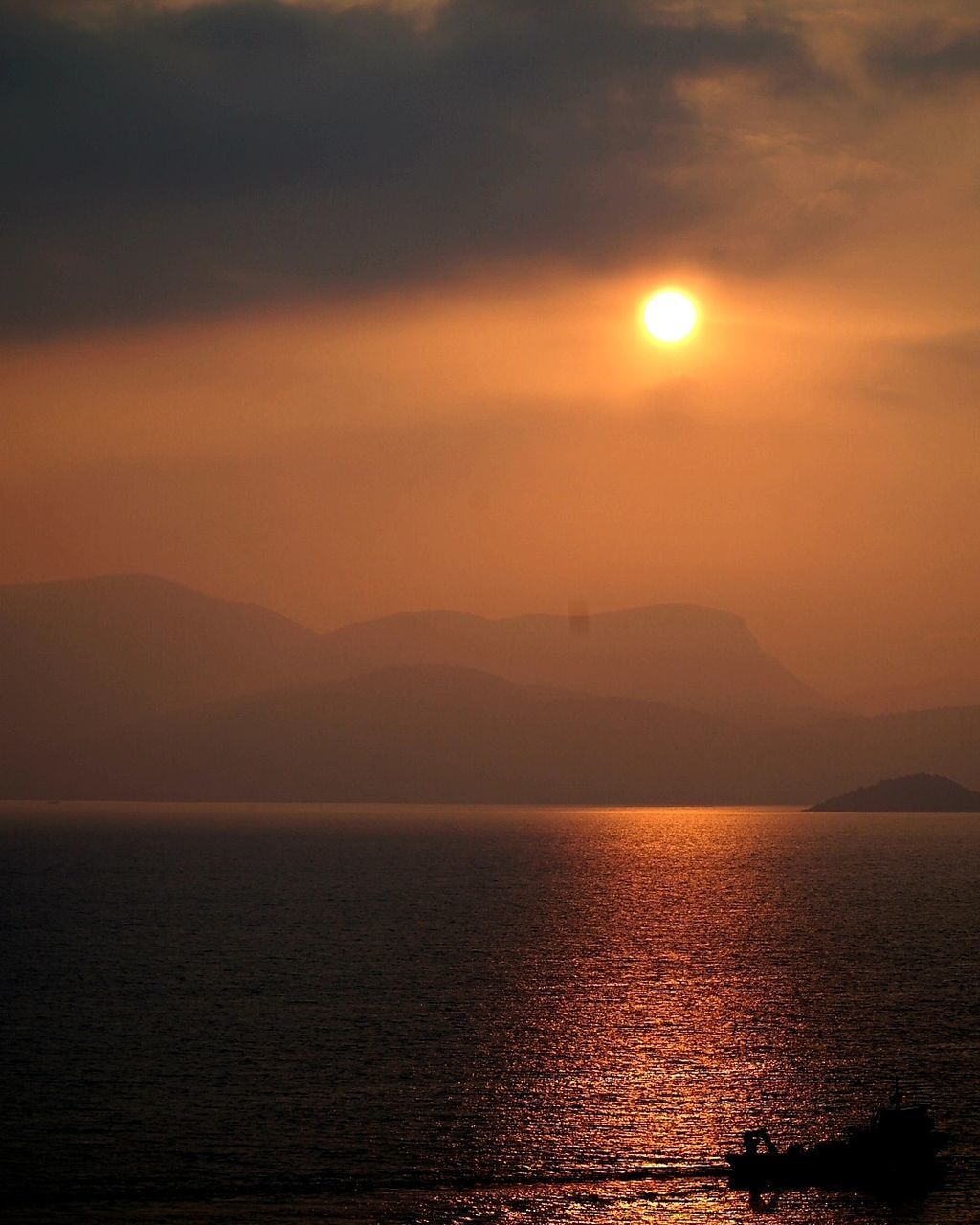 SCENIC VIEW OF SEA AGAINST ORANGE SKY DURING SUNSET