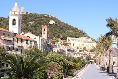 Panoramic view of buildings and trees against sky in city