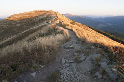 View of dirt road passing through landscape