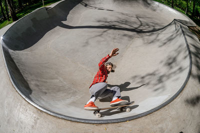 Midsection of man skateboarding on skateboard