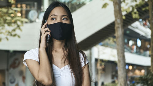 Portrait of young woman standing outdoors