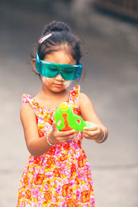 Full length of a girl holding mask