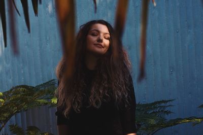 Portrait of a smiling young woman standing outdoors