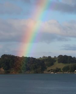 Rainbow over sea against sky