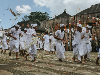 Group of people in street market against sky