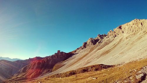 Scenic view of mountains against clear blue sky