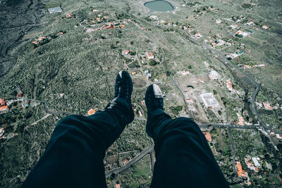 Low section of man over green landscape