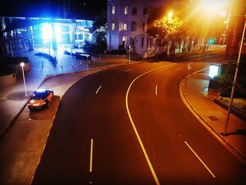 Cars on illuminated street at night