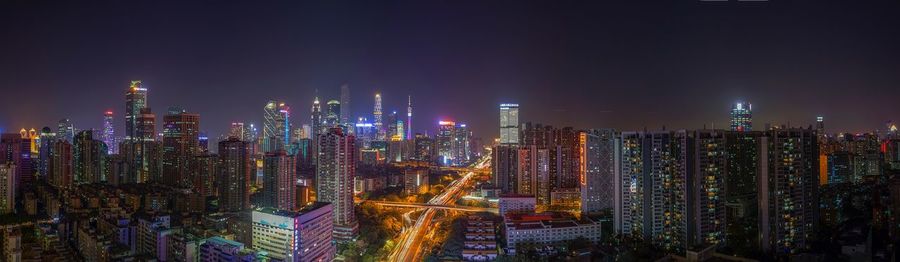 Illuminated cityscape against sky at night