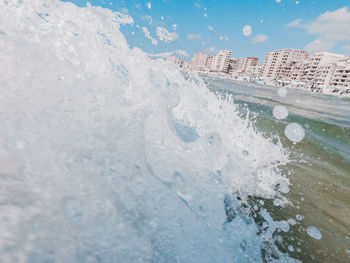 Sea waves splashing on snow