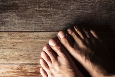 Low section of person on hardwood floor