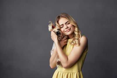 Portrait of smiling young woman over white background