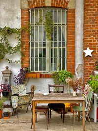 Empty chairs and tables in front of house