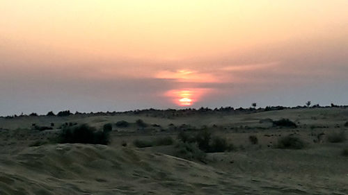 Scenic view of landscape against sky during sunset