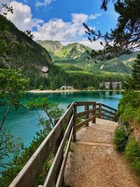 Scenic view of lake by mountains against sky