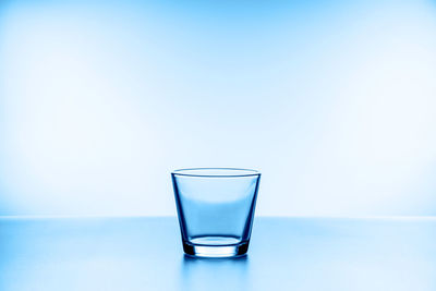 Close-up of drink on table against blue background