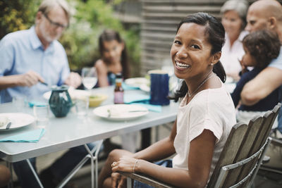 Portrait of a smiling young woman sitting on table