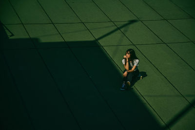 High angle view of woman sitting on floor