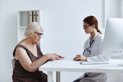 Woman sitting on table