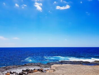 Scenic view of sea against blue sky