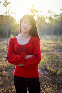 Beautiful young woman standing on land